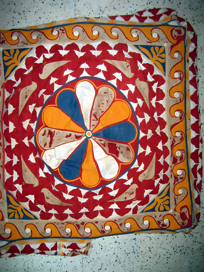 Appliqué sun-wheel on red