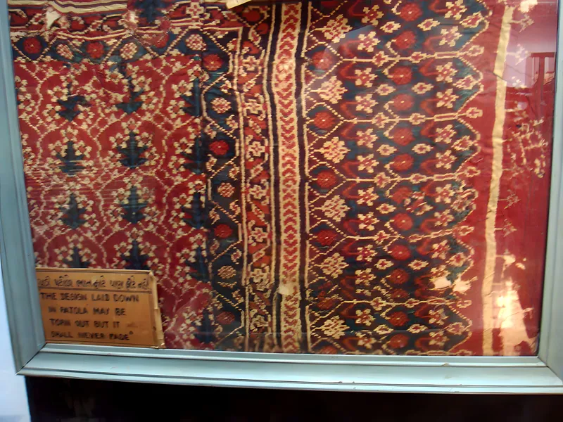 Framed patola in the weaver's home