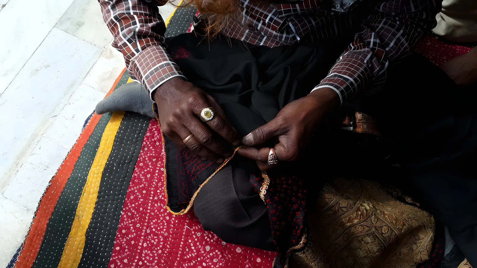 Hand-stitching on a striped ground