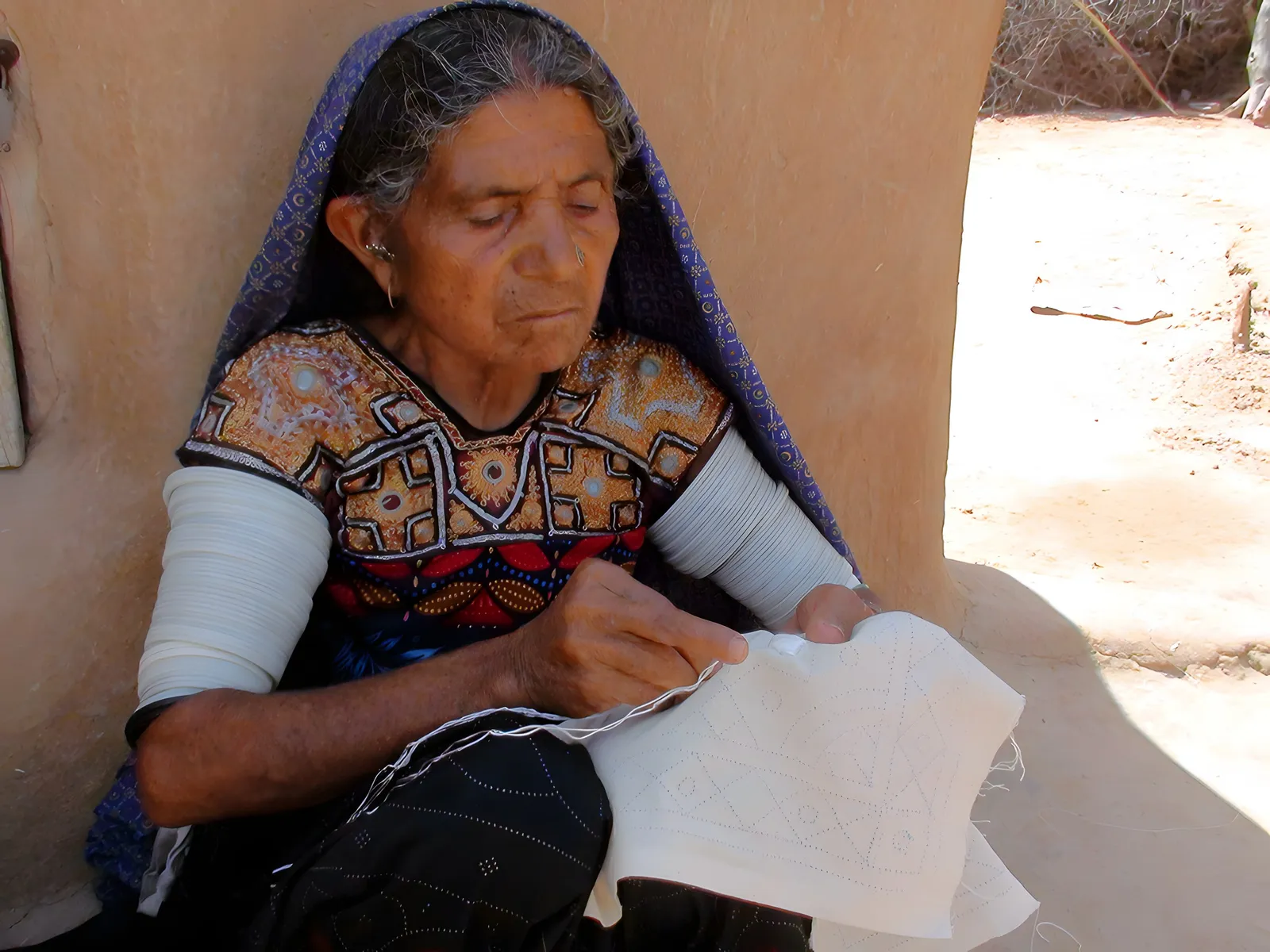 Embroidering by hand, Kutch