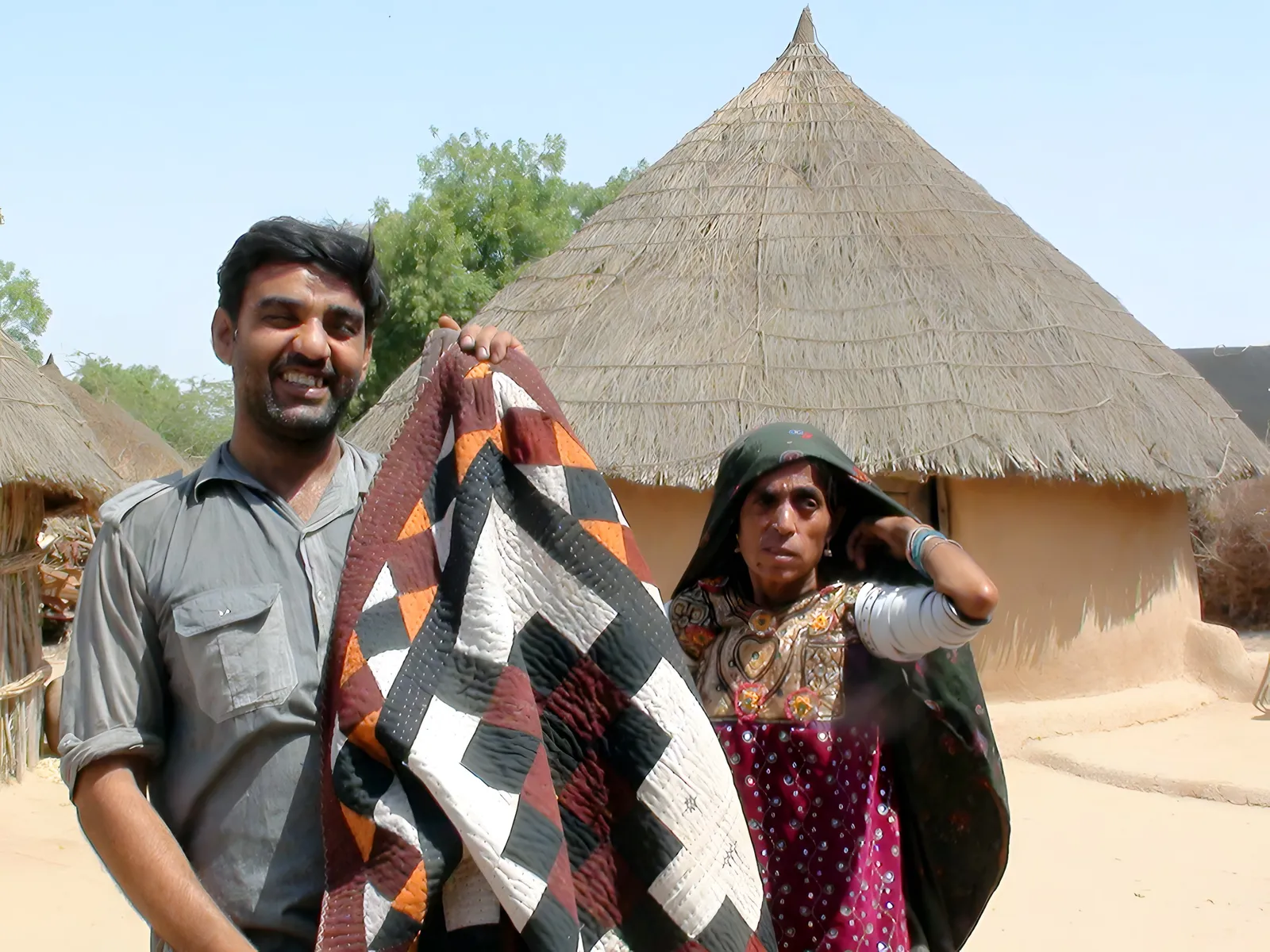 A finished quilt outside a bhunga