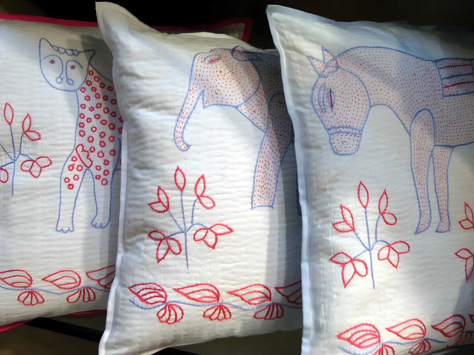Kantha-embroidered animal cushions