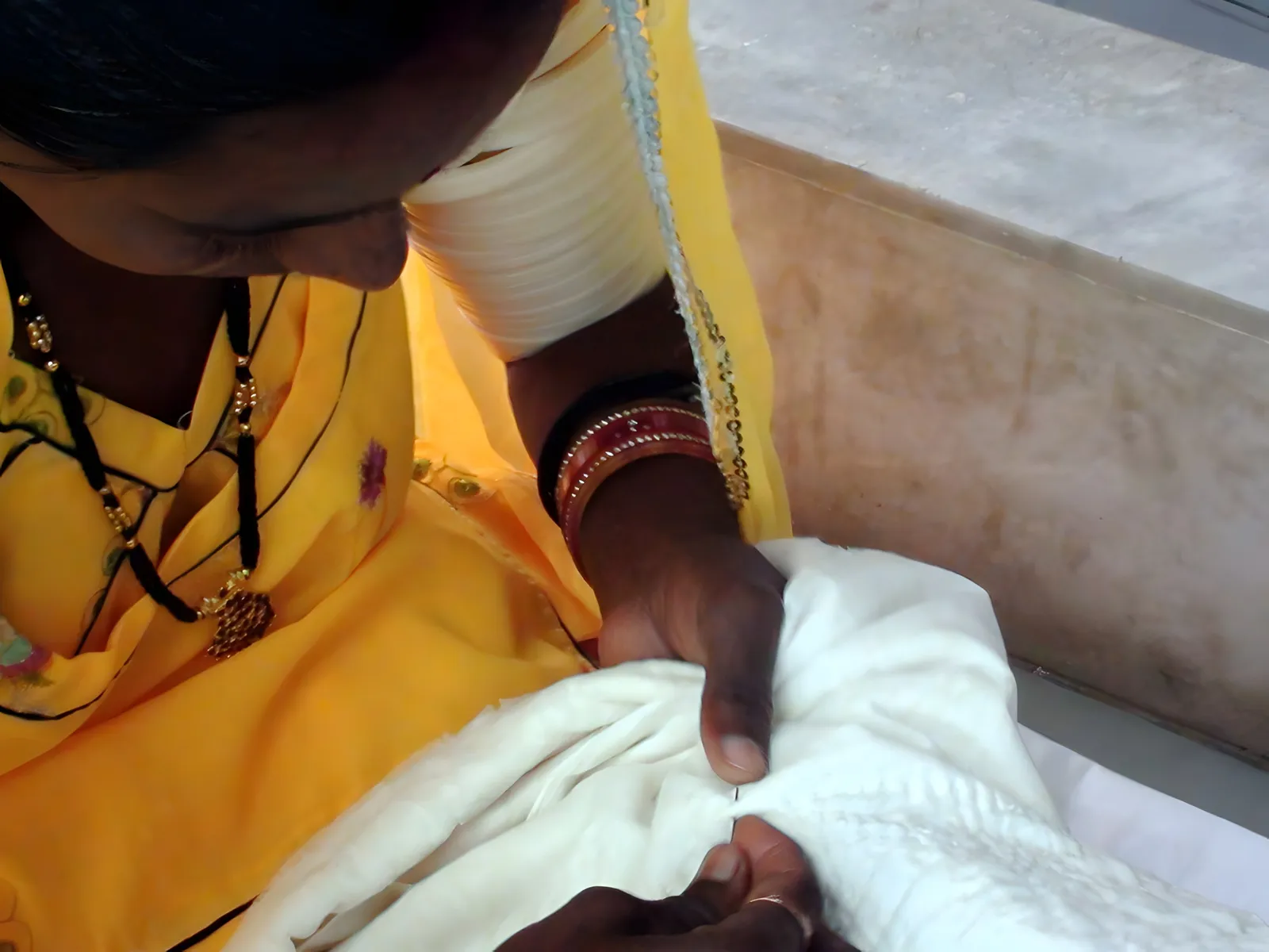An artisan hand-quilting in the workshop