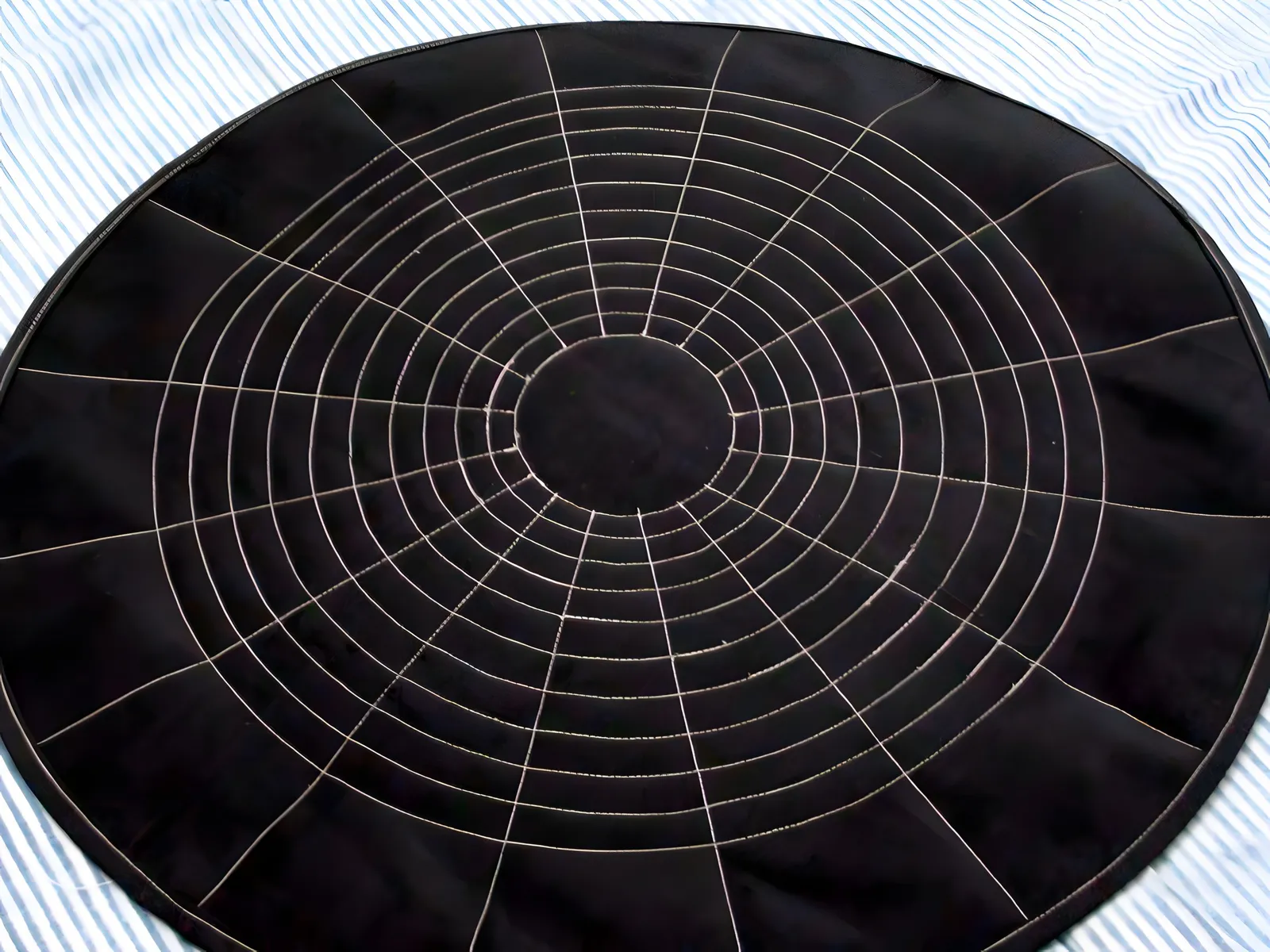 Concentric hand-quilting on charcoal cotton